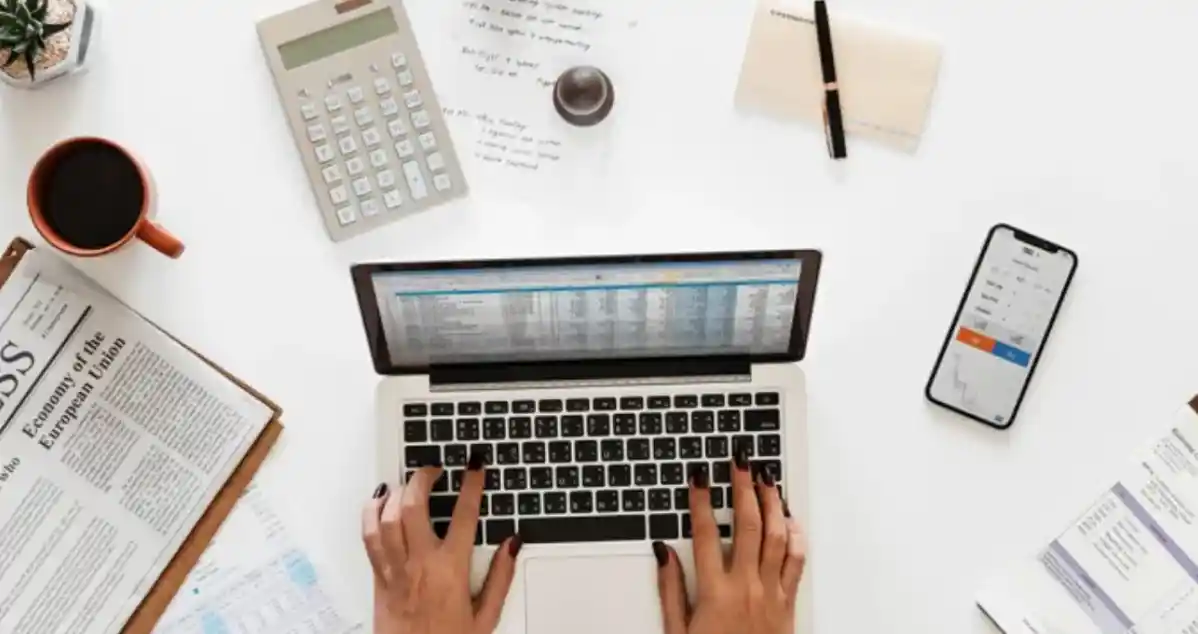 hands on a laptop on a workdesk